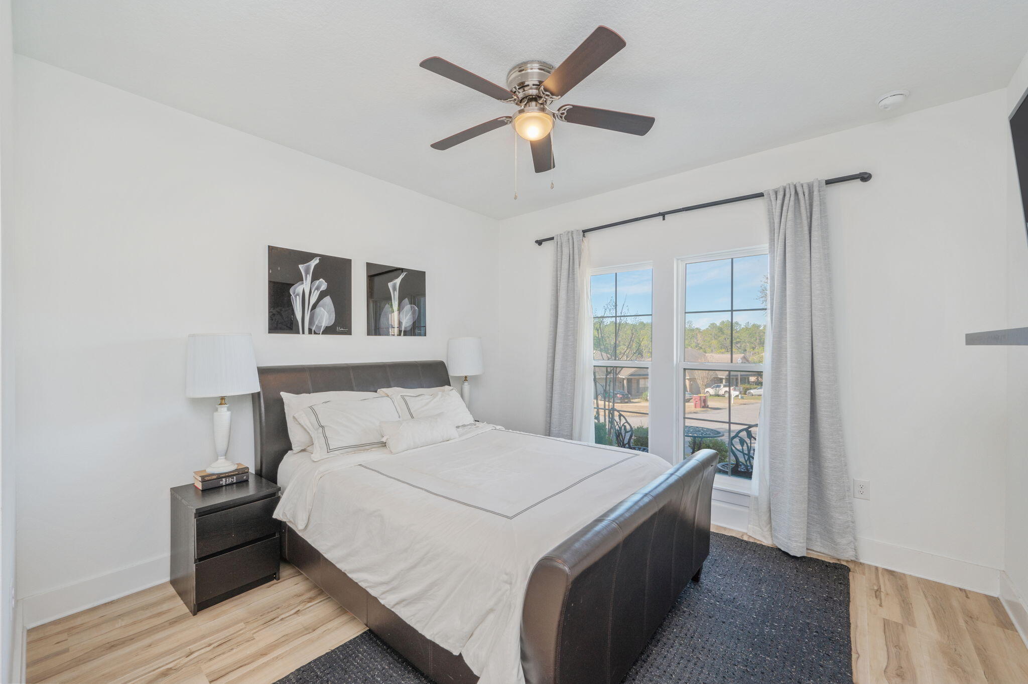 667 Red Fern Road Crestview, FL 32536 - Photo 20 of 43 a bedroom with a large bed and a large window