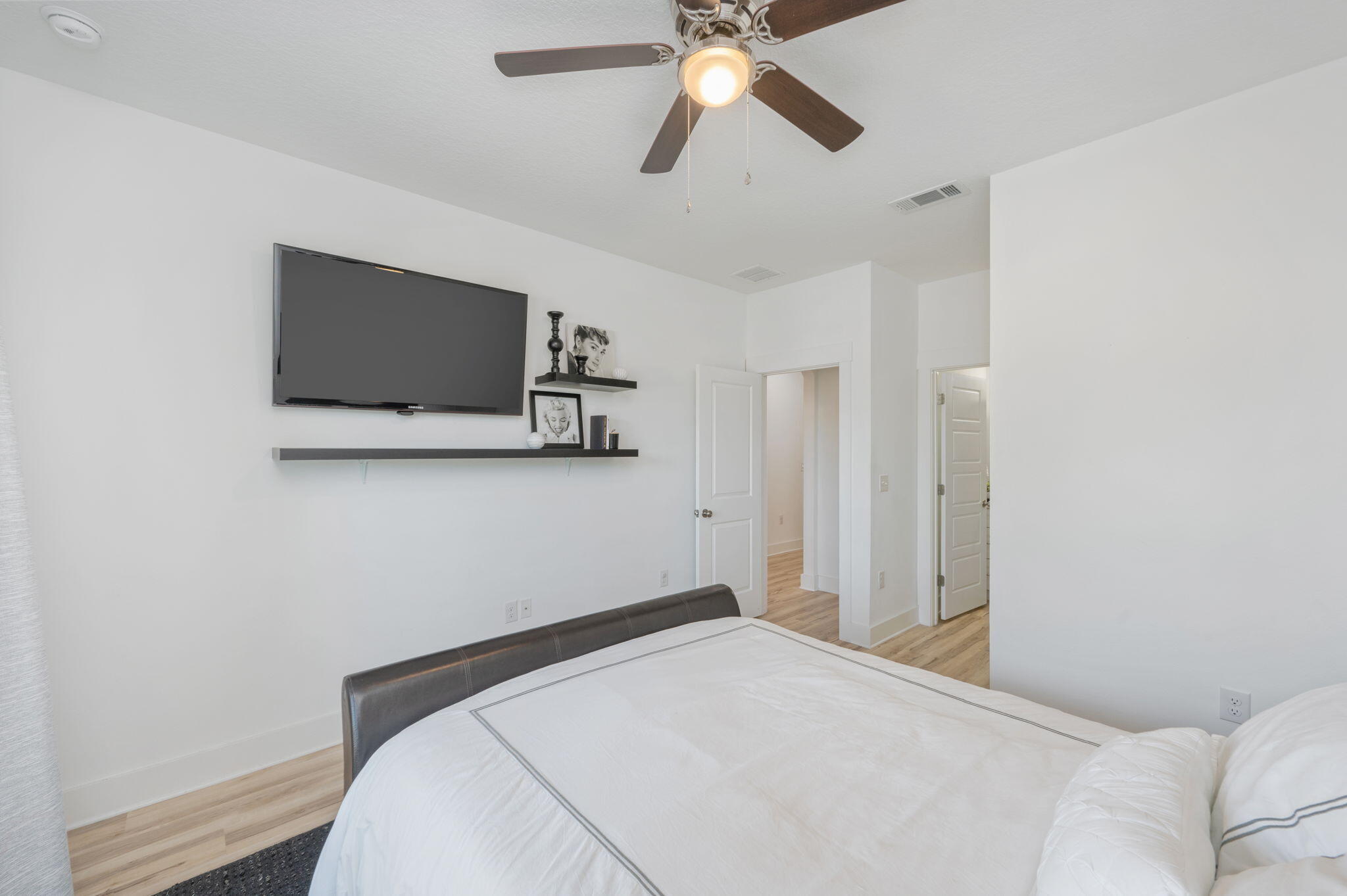 667 Red Fern Road Crestview, FL 32536 - Photo 21 of 43 a bedroom with a bed and a flat screen tv