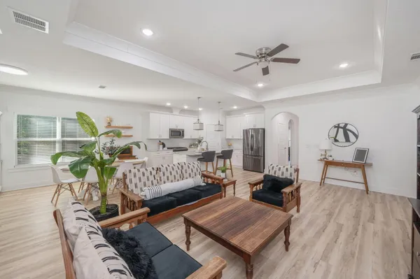 a living room with furniture and wooden floor