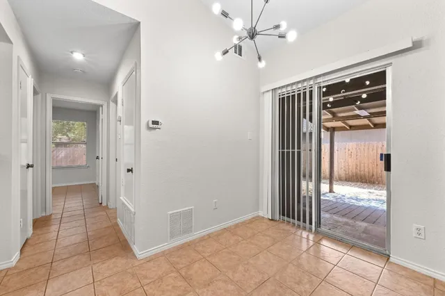 a view of a hallway with closet and a livingroom view