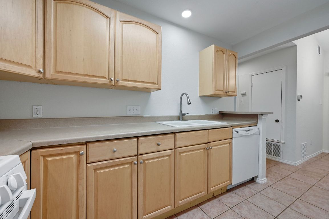 9711 Curlew Drive Austin, TX 78748 - Photo 9 of 21 a kitchen with white cabinets