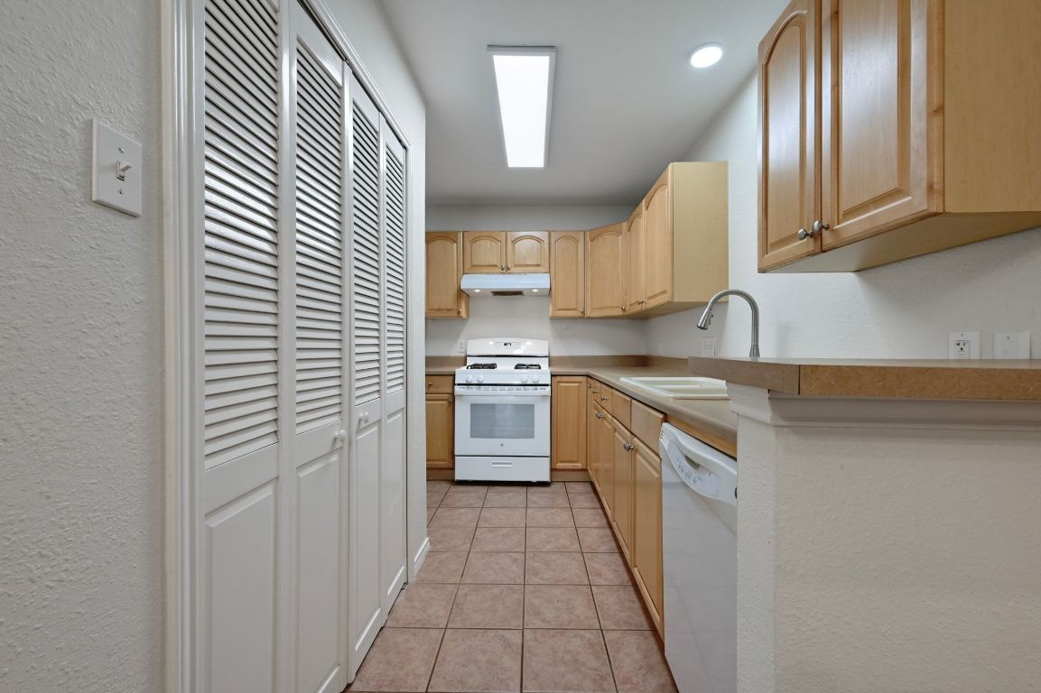 9711 Curlew Drive Austin, TX 78748 - Photo 10 of 21 a kitchen with stainless steel appliances granite countertop a sink and cabinets