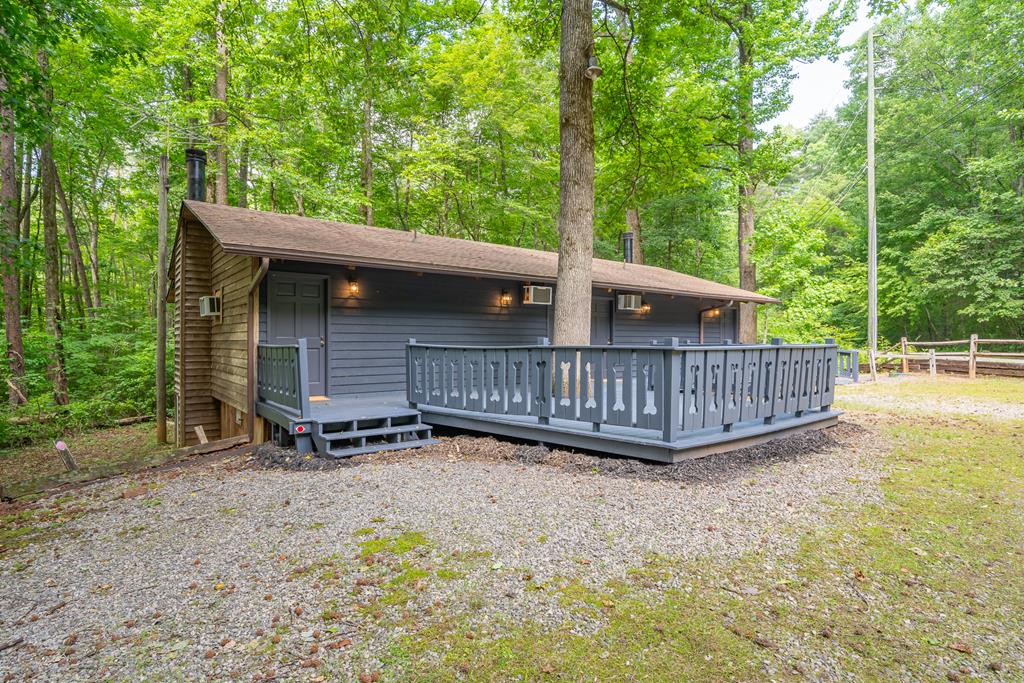 a view of a wooden deck with a fence and a yard