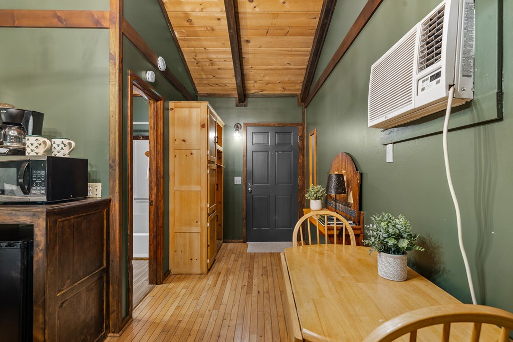 3573 Highway 356 Sautee Nacoochee, GA 30571 - Photo 25 of 53 a kitchen with stainless steel appliances kitchen island granite countertop a refrigerator a stove and a wooden cabinets