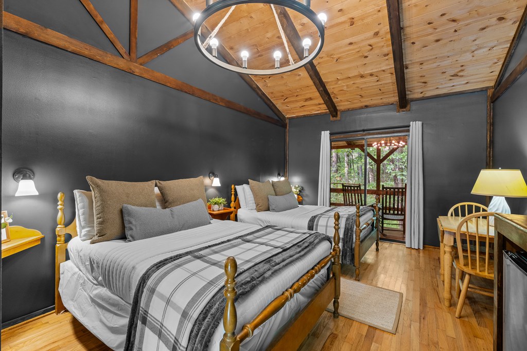 3573 Highway 356 Sautee Nacoochee, GA 30571 - Photo 34 of 53 a bedroom with a bed a dresser and next to a window