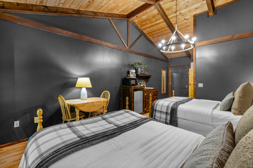 3573 Highway 356 Sautee Nacoochee, GA 30571 - Photo 36 of 53 a bedroom with bed a chandelier and a window