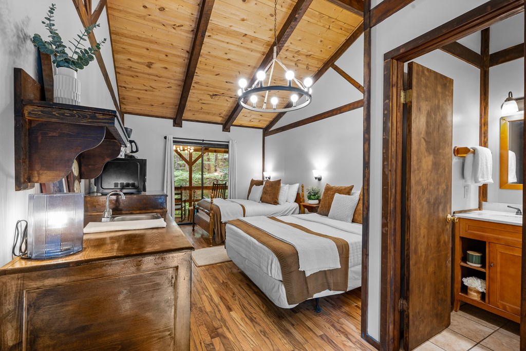 3573 Highway 356 Sautee Nacoochee, GA 30571 - Photo 44 of 53 a bedroom with a bed and a chandelier