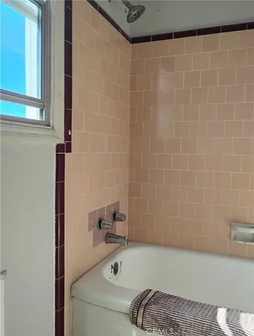 a bathroom with a tub and a window