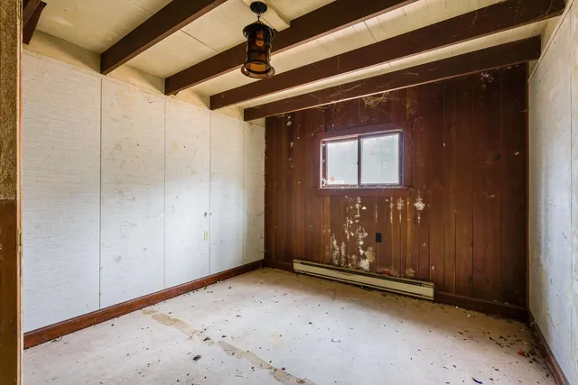 a view of a room with a wooden door