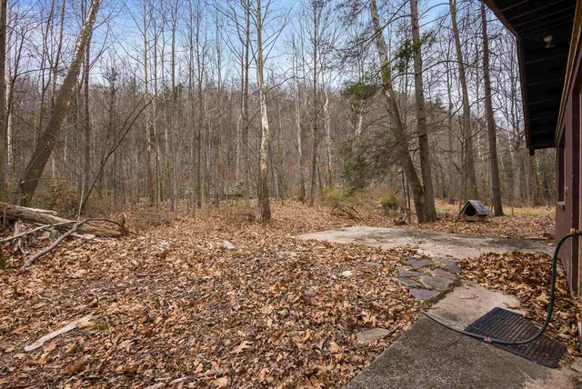 a view of a house with a yard and sitting area