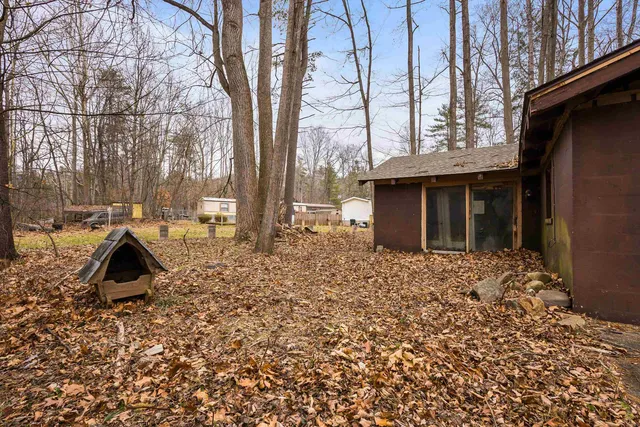 a view of backyard with wooden fence