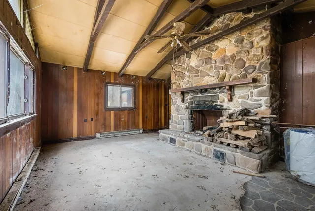a view of a livingroom with furniture and a fireplace