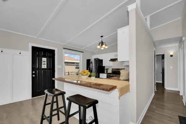 a kitchen with kitchen island a counter top space a stainless steel appliances and cabinets