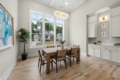 a view of a dining room with furniture wooden floor and chandelier