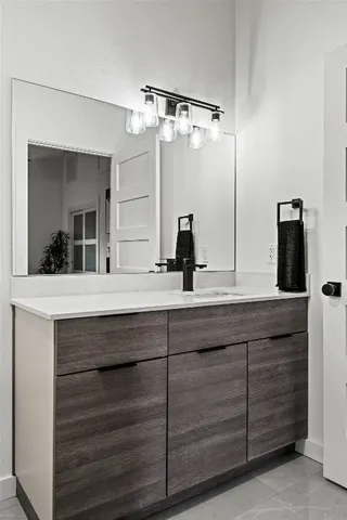 a bathroom with a double vanity sink and mirror
