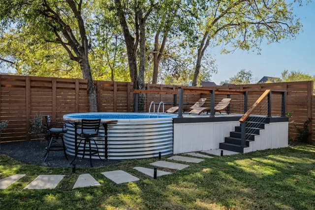 a view of a chairs setting in the backyard
