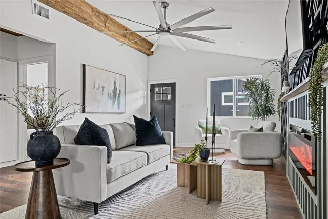 a living room with furniture and wooden floor