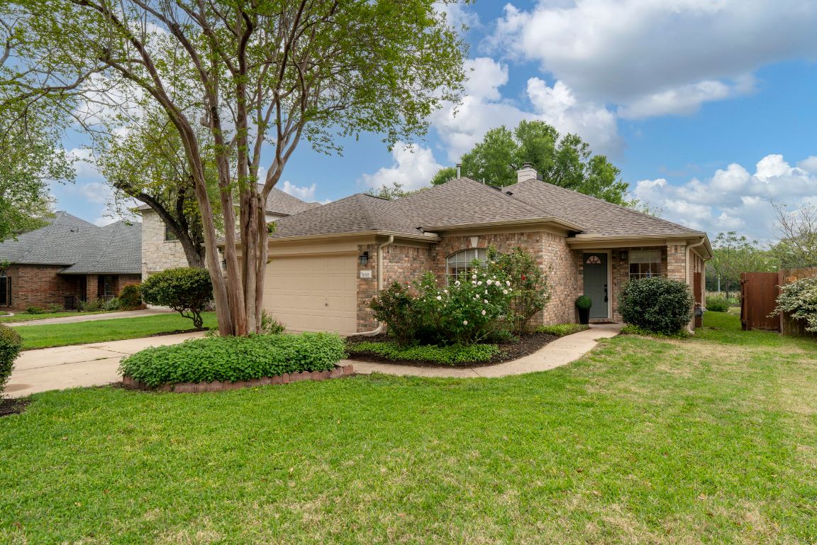 a view of a house with a yard and a garden