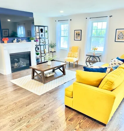 a living room with furniture and a fireplace