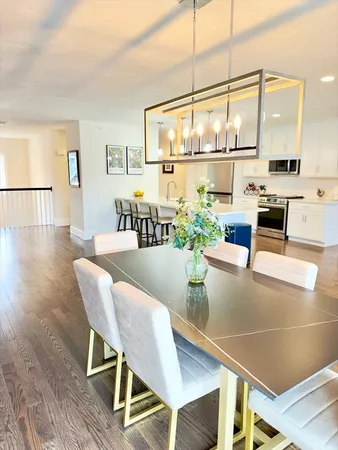 a dining room with furniture and wooden floor