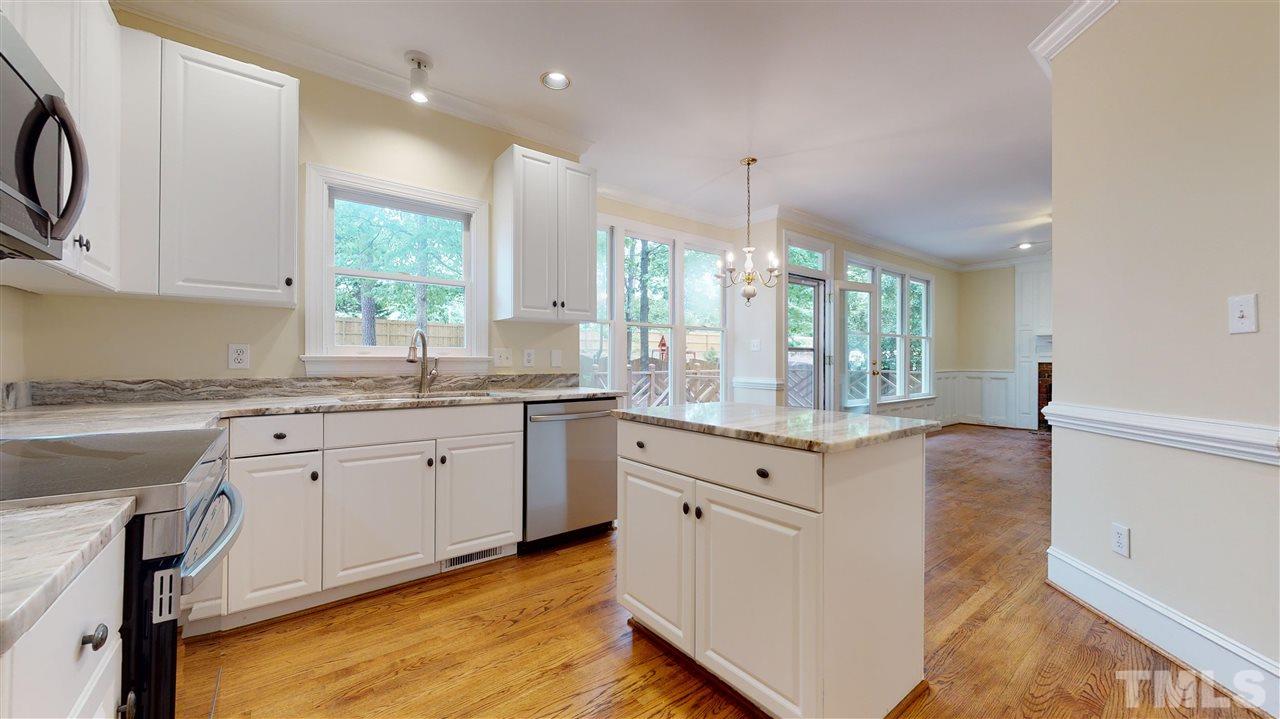 9509 Brimstone Lane Raleigh, NC 27613 - Photo 12 of 30 Kitchen has spacious Breakfast Room, new stainless steel appliances & sink (Samsung Stove & microwave +Bosch Dishwasher), new granite counters. Pantry. New Finish on Hardwood Floor. Cased opening to Dining Room. Overlooks back yard.