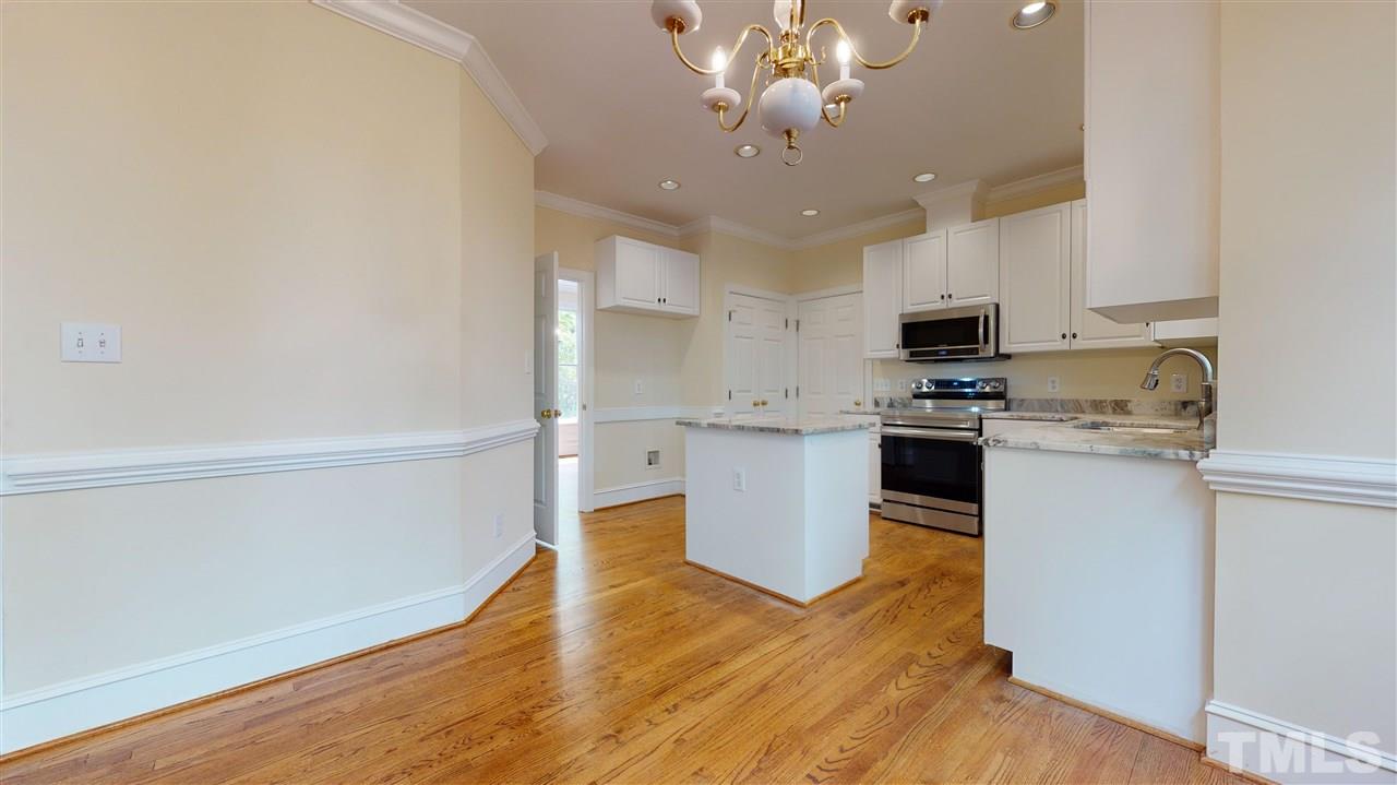9509 Brimstone Lane Raleigh, NC 27613 - Photo 13 of 30 Kitchen has spacious Breakfast Room, new stainless steel appliances & sink (Samsung Stove & microwave +Bosch Dishwasher), new granite counters. Pantry. New Finish on Hardwood Floor. Cased opening to Dining Room. Overlooks back yard.