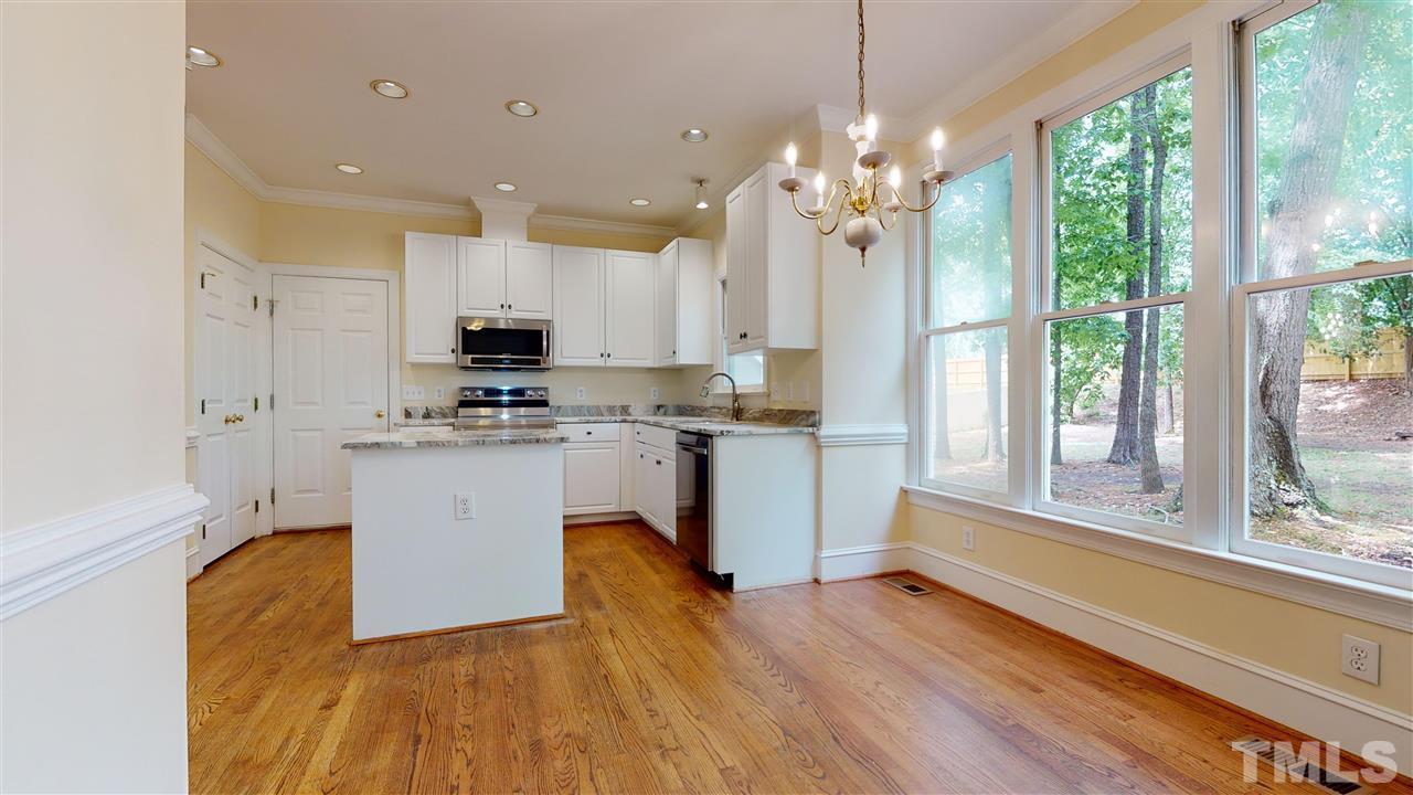 9509 Brimstone Lane Raleigh, NC 27613 - Photo 14 of 30 Kitchen has spacious Breakfast Room, new stainless steel appliances & sink (Samsung Stove & microwave +Bosch Dishwasher), new granite counters. Pantry. New Finish on Hardwood Floor. Cased opening to Dining Room. Overlooks back yard..