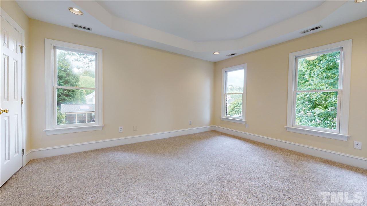 9509 Brimstone Lane Raleigh, NC 27613 - Photo 17 of 30 Master Bedroom has tray ceiling, walk-in closet + Master Bathroom with double bowl vanity, separate shower, jetted tub, linen closet, ceramic tile floor and a window. New carpet.