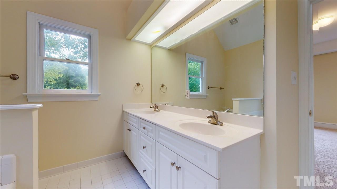 9509 Brimstone Lane Raleigh, NC 27613 - Photo 19 of 30 Master Bathroom with double bowl vanity, ceramic tile floor and a window for natural light .