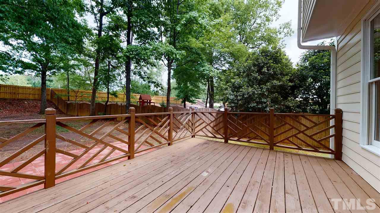 9509 Brimstone Lane Raleigh, NC 27613 - Photo 25 of 30 Deck overlooks private back yard. Walk down the steps and to the patio.