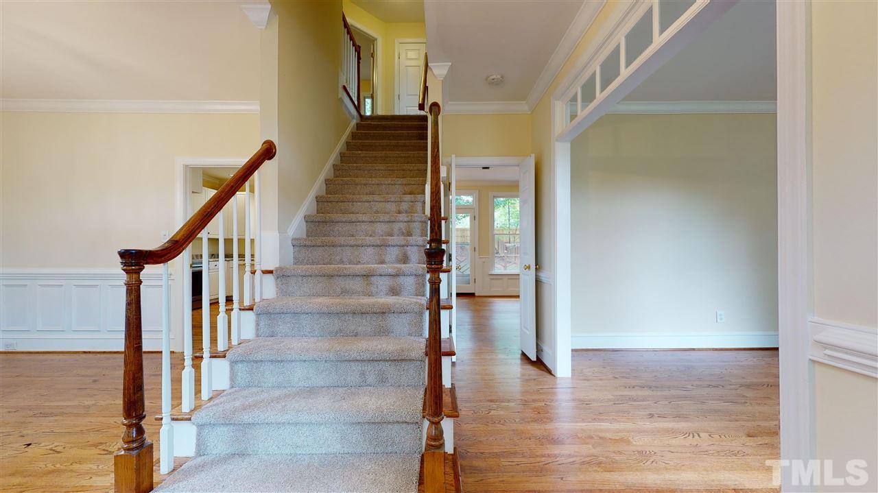 9509 Brimstone Lane Raleigh, NC 27613 - Photo 4 of 30 Stairs from Foyer to 2nd floor Living Room to the right and Dining Room to the left. Family Room is forward and on the back side of the house.