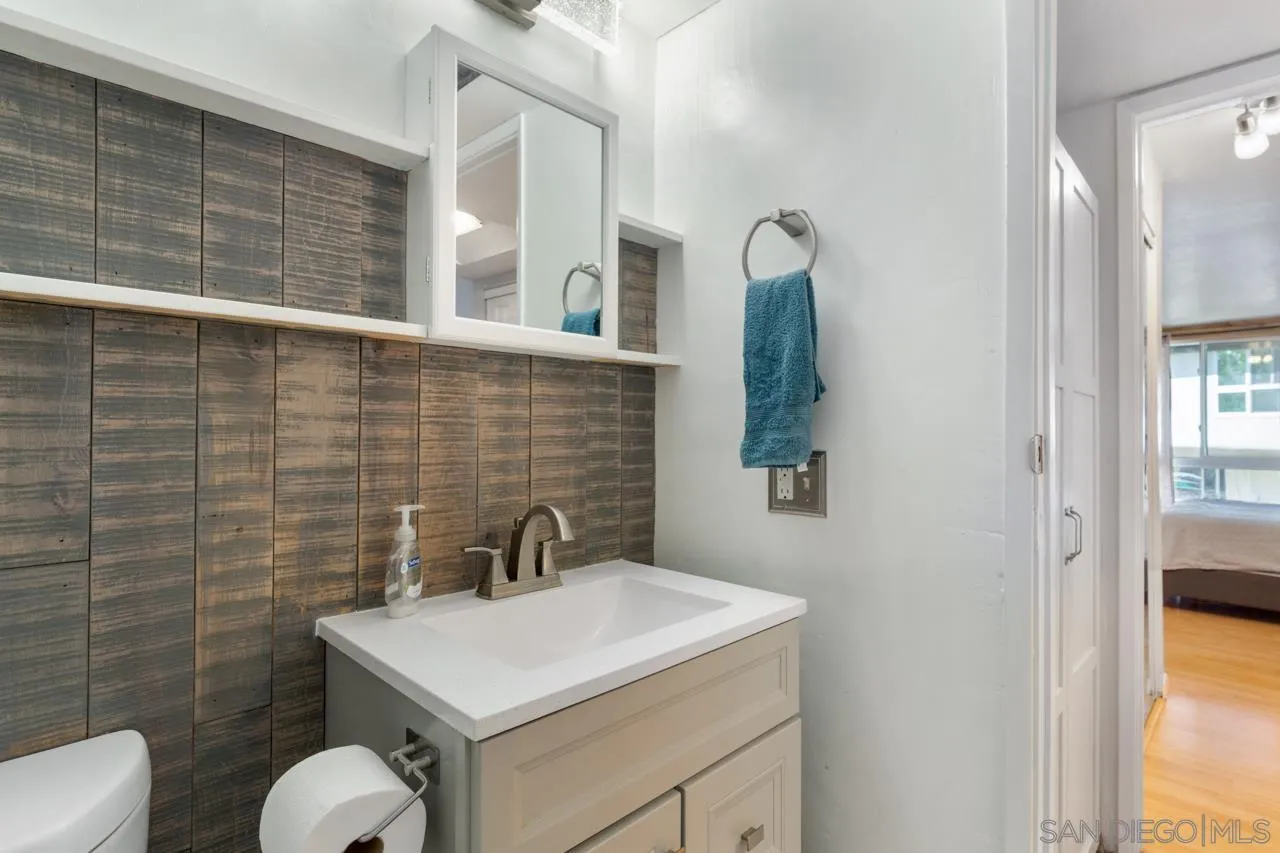 6191 Rancho Mission Road, Unit 308 San Diego, CA 92108 - Photo 14 of 31 a bathroom with a toilet sink and mirror