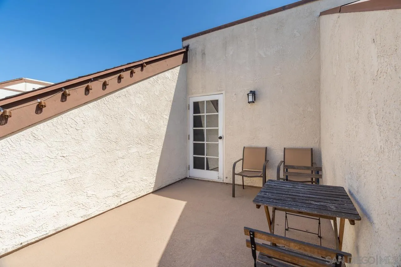 6191 Rancho Mission Road, Unit 308 San Diego, CA 92108 - Photo 19 of 31 a balcony with a bench and white walls