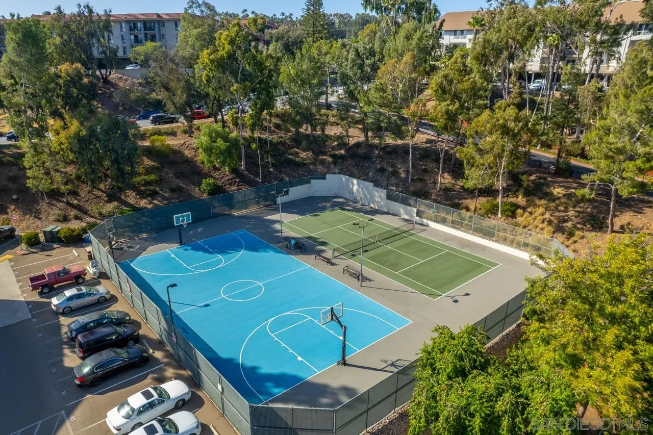 6191 Rancho Mission Road, Unit 308 San Diego, CA 92108 - Photo 26 of 31 an aerial view of a tennis ground with large trees