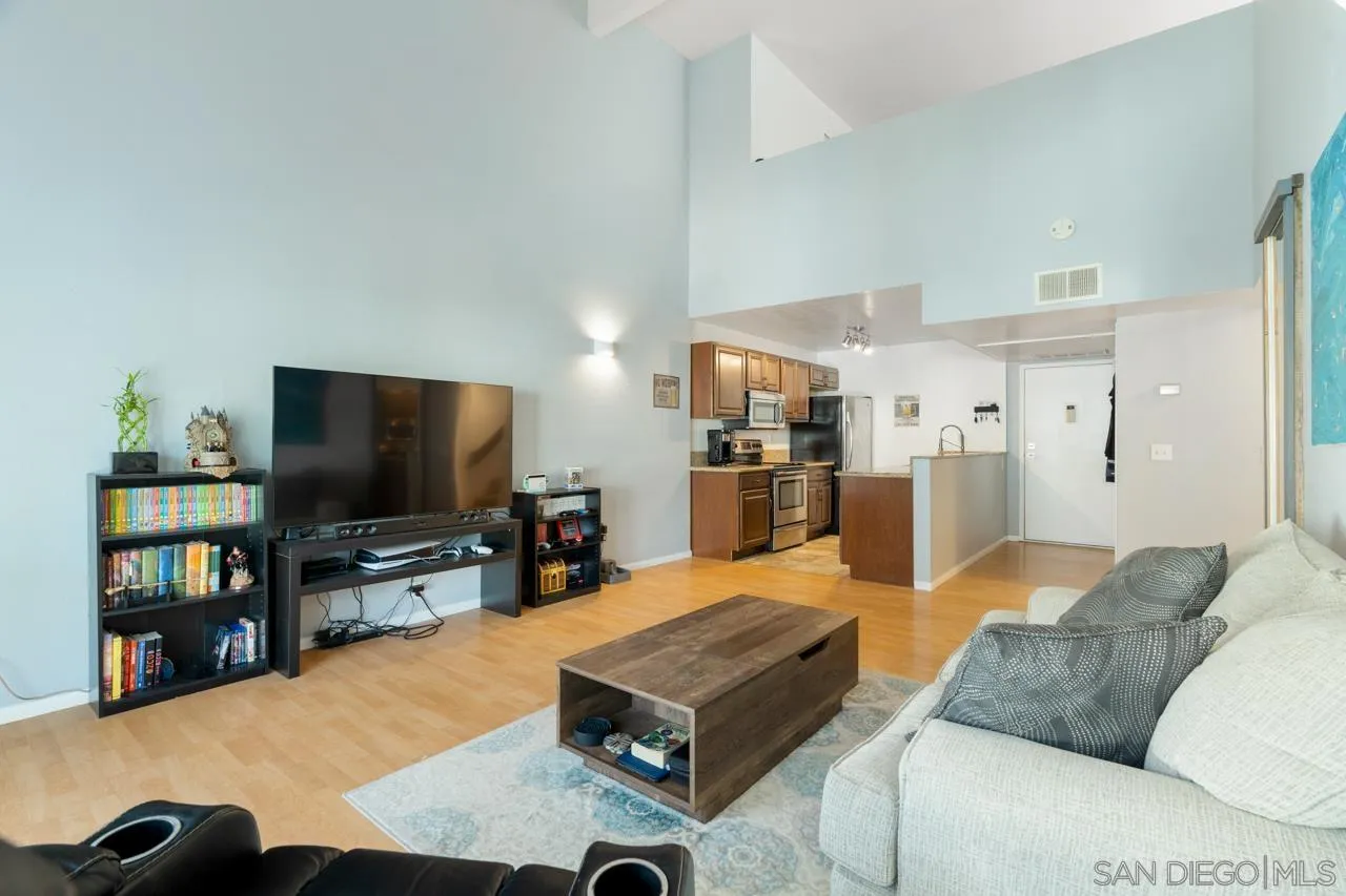 6191 Rancho Mission Road, Unit 308 San Diego, CA 92108 - Photo 4 of 31 a living room with furniture and a flat screen tv