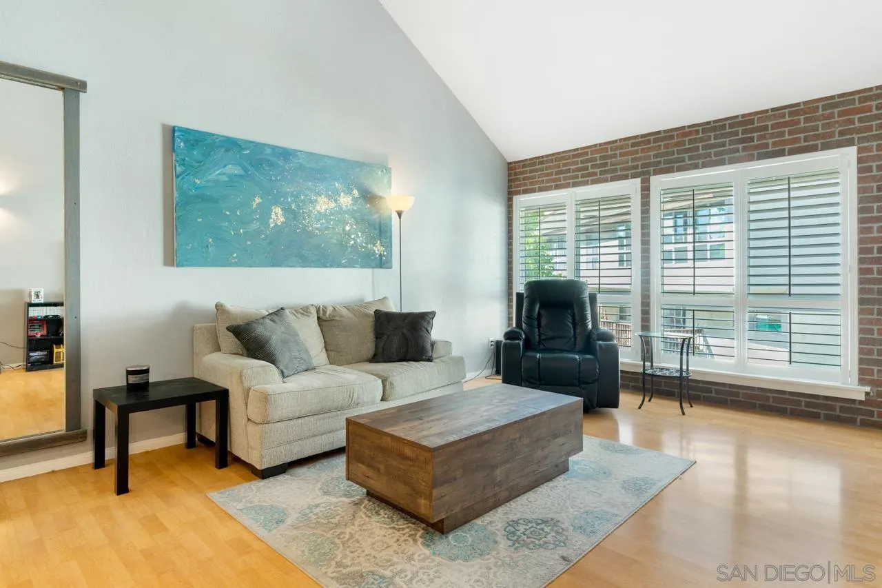 6191 Rancho Mission Road, Unit 308 San Diego, CA 92108 - Photo 5 of 31 a living room with furniture and a large window