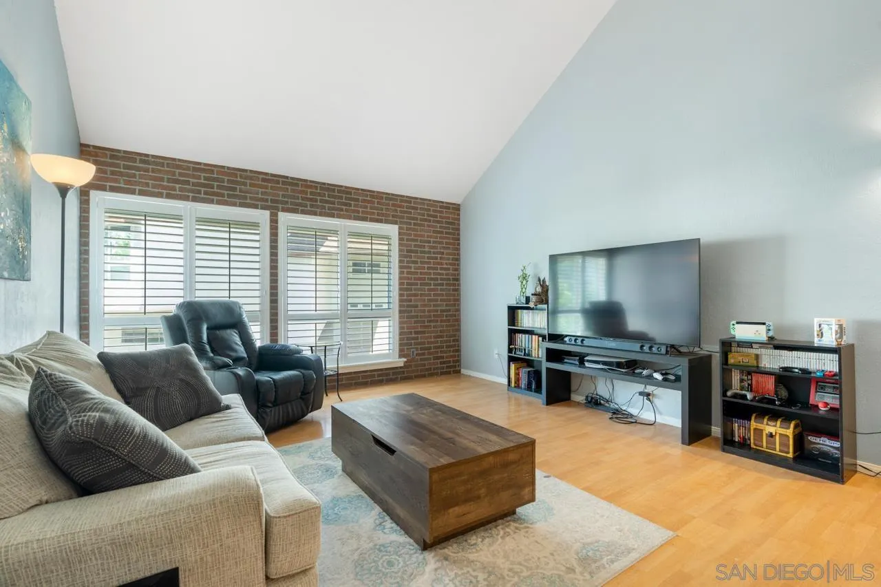 6191 Rancho Mission Road, Unit 308 San Diego, CA 92108 - Photo 6 of 31 a living room with furniture and a flat screen tv