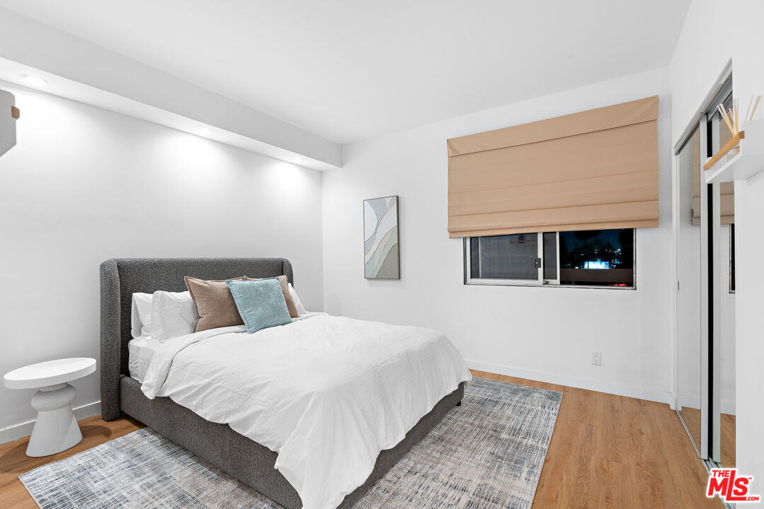 321 South San Vicente Boulevard, Unit 507 Los Angeles, CA 90048 - Photo 17 of 30 a bedroom with a bed and a view of bathroom