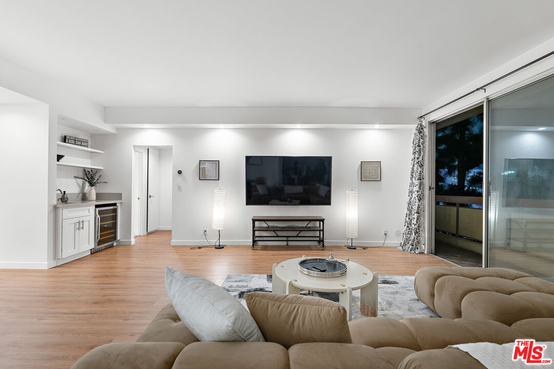 321 South San Vicente Boulevard, Unit 507 Los Angeles, CA 90048 - Photo 2 of 30 a living room with furniture and a flat screen tv