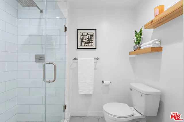 a white toilet sitting next to a bathroom sink