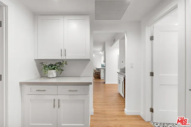 a view of kitchen with stainless steel appliances cabinets and wooden floor
