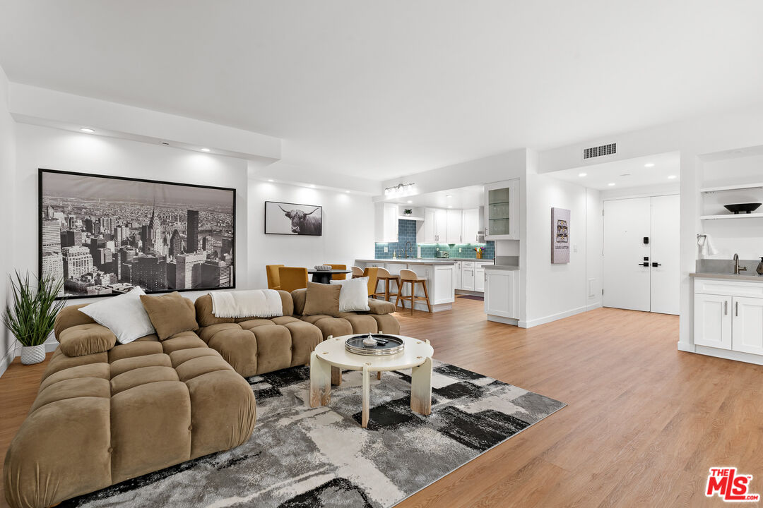 321 South San Vicente Boulevard, Unit 507 Los Angeles, CA 90048 - Photo 25 of 30 a living room with furniture wooden floor and a large window