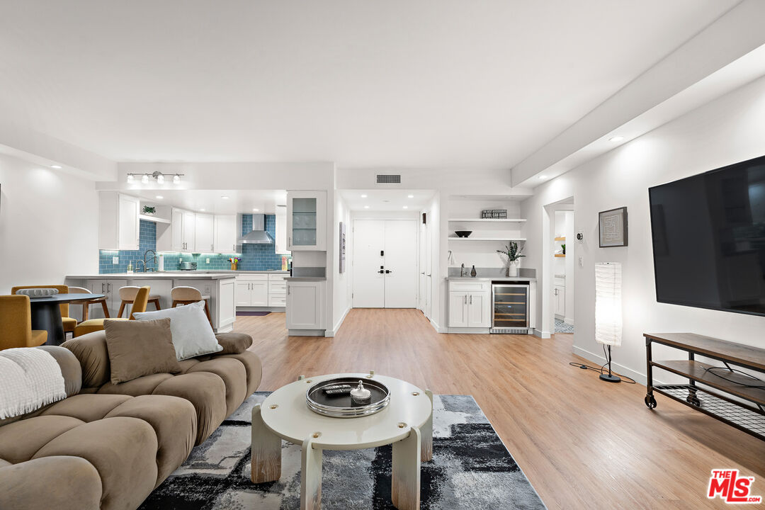 321 South San Vicente Boulevard, Unit 507 Los Angeles, CA 90048 - Photo 26 of 30 a living room with furniture and a flat screen tv