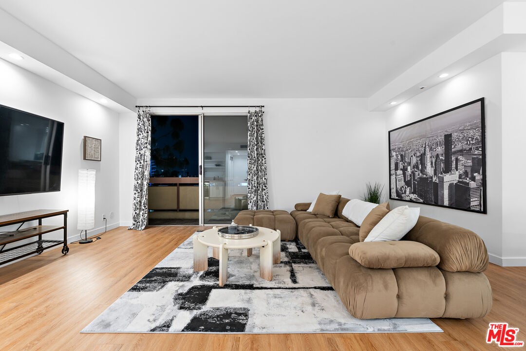 321 South San Vicente Boulevard, Unit 507 Los Angeles, CA 90048 - Photo 3 of 30 a living room with furniture and a flat screen tv