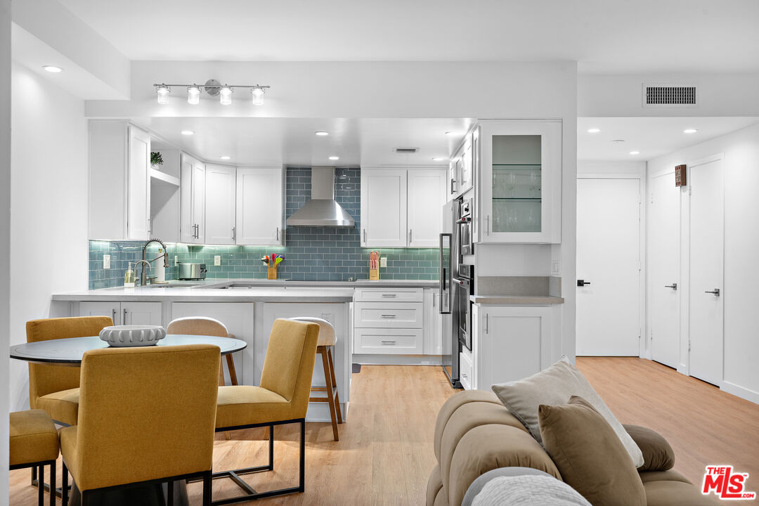 321 South San Vicente Boulevard, Unit 507 Los Angeles, CA 90048 - Photo 5 of 30 a living room with stainless steel appliances granite countertop furniture a fireplace and a view of kitchen