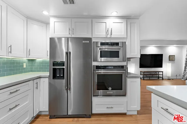 a kitchen with a refrigerator stove and microwave