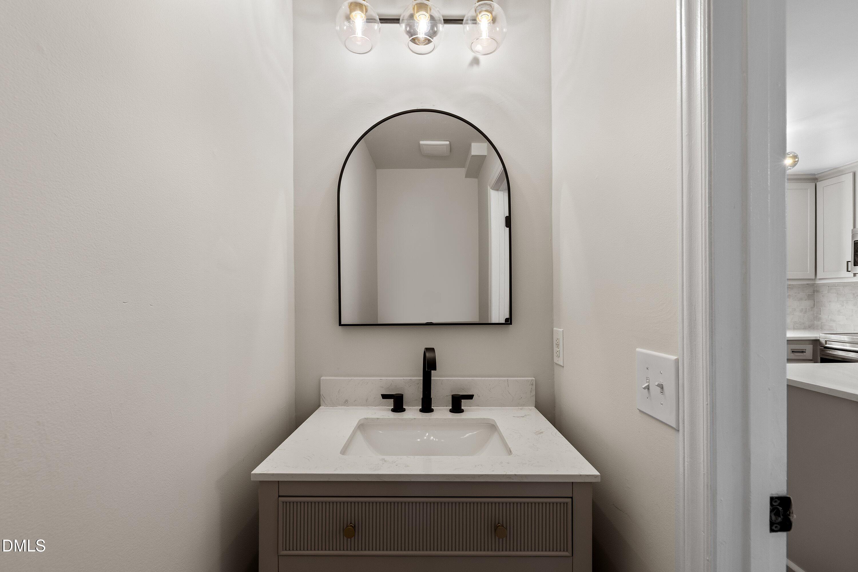 389 East Williams Street Angier, NC 27501 - Photo 14 of 26 a bathroom with a sink and a mirror