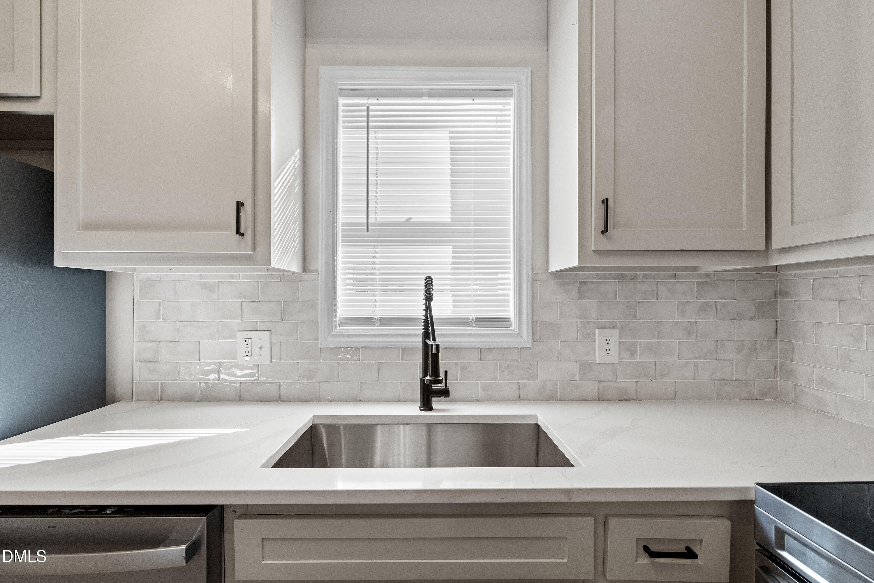 389 East Williams Street Angier, NC 27501 - Photo 15 of 26 a kitchen with a sink and cabinets
