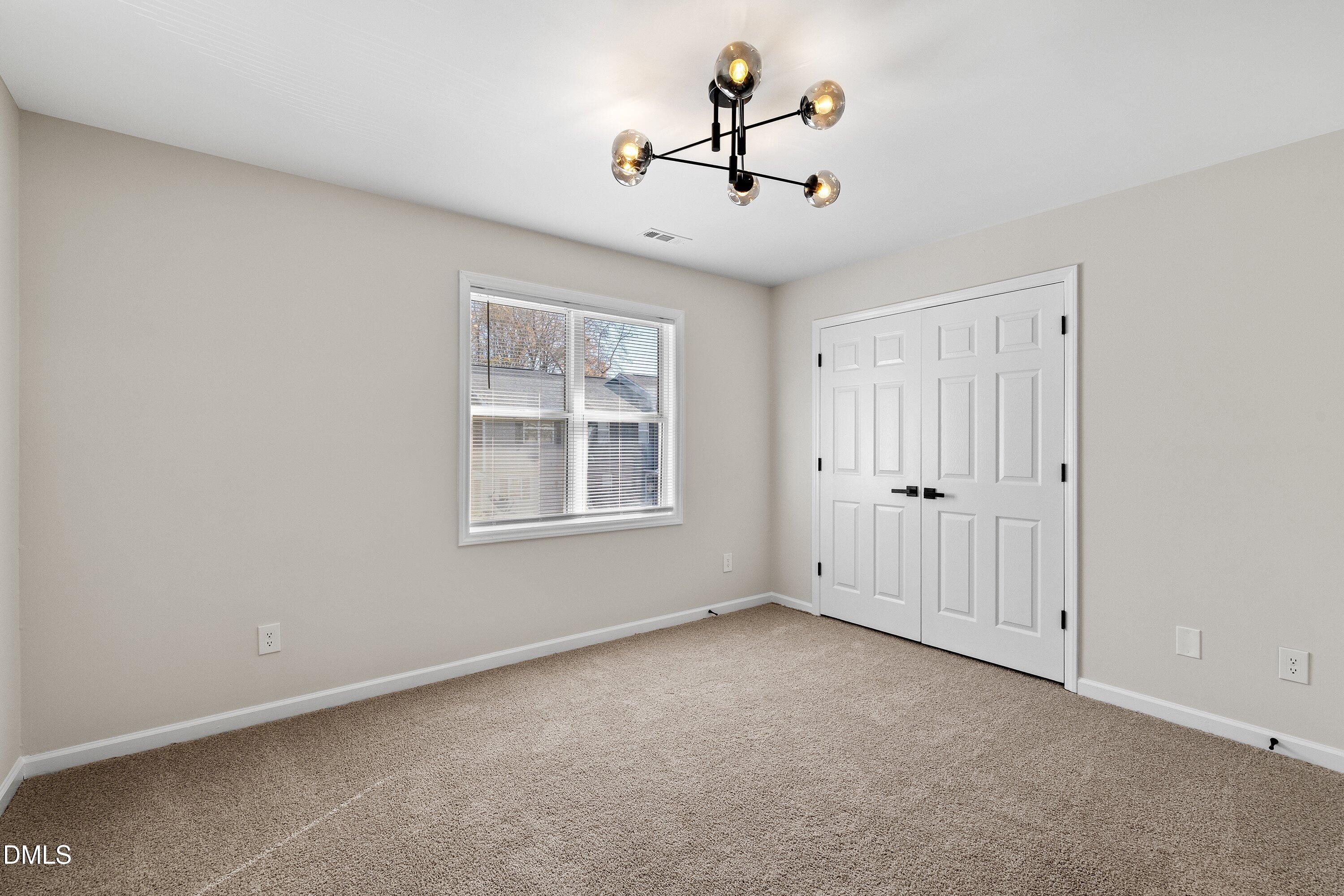 389 East Williams Street Angier, NC 27501 - Photo 16 of 26 a view of an empty room with a window