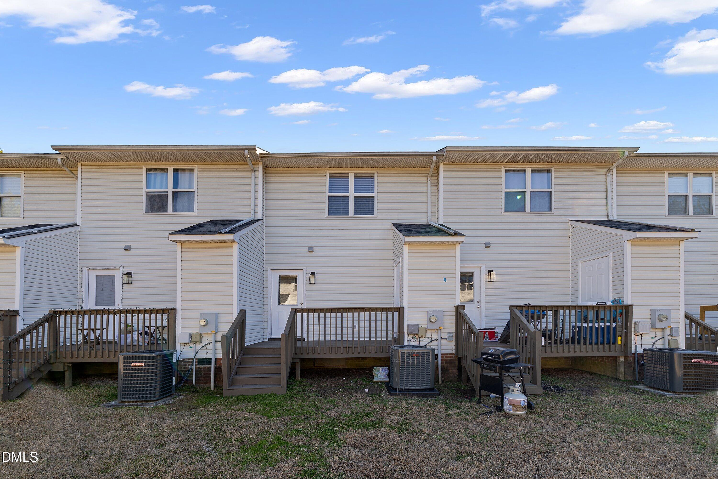 389 East Williams Street Angier, NC 27501 - Photo 24 of 26 a backyard of a house with barbeque oven table and chairs